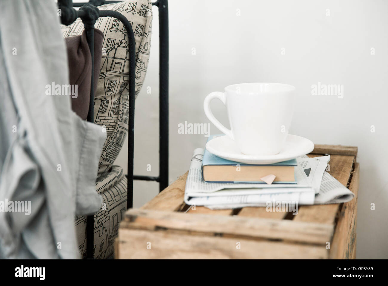 Coffee cup and book on night table Stock Photo