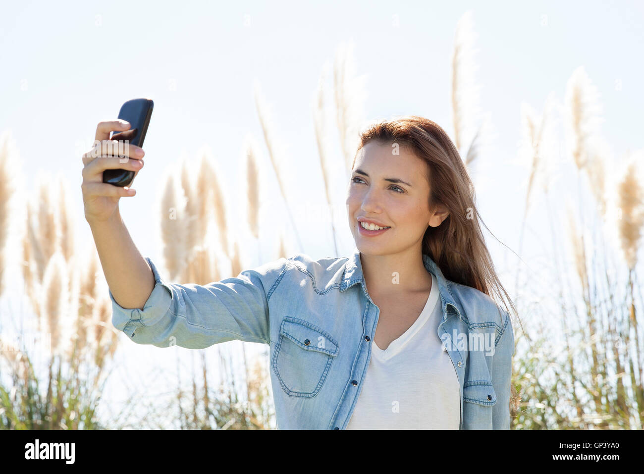 Woman posing for a selfie outdoors Stock Photo