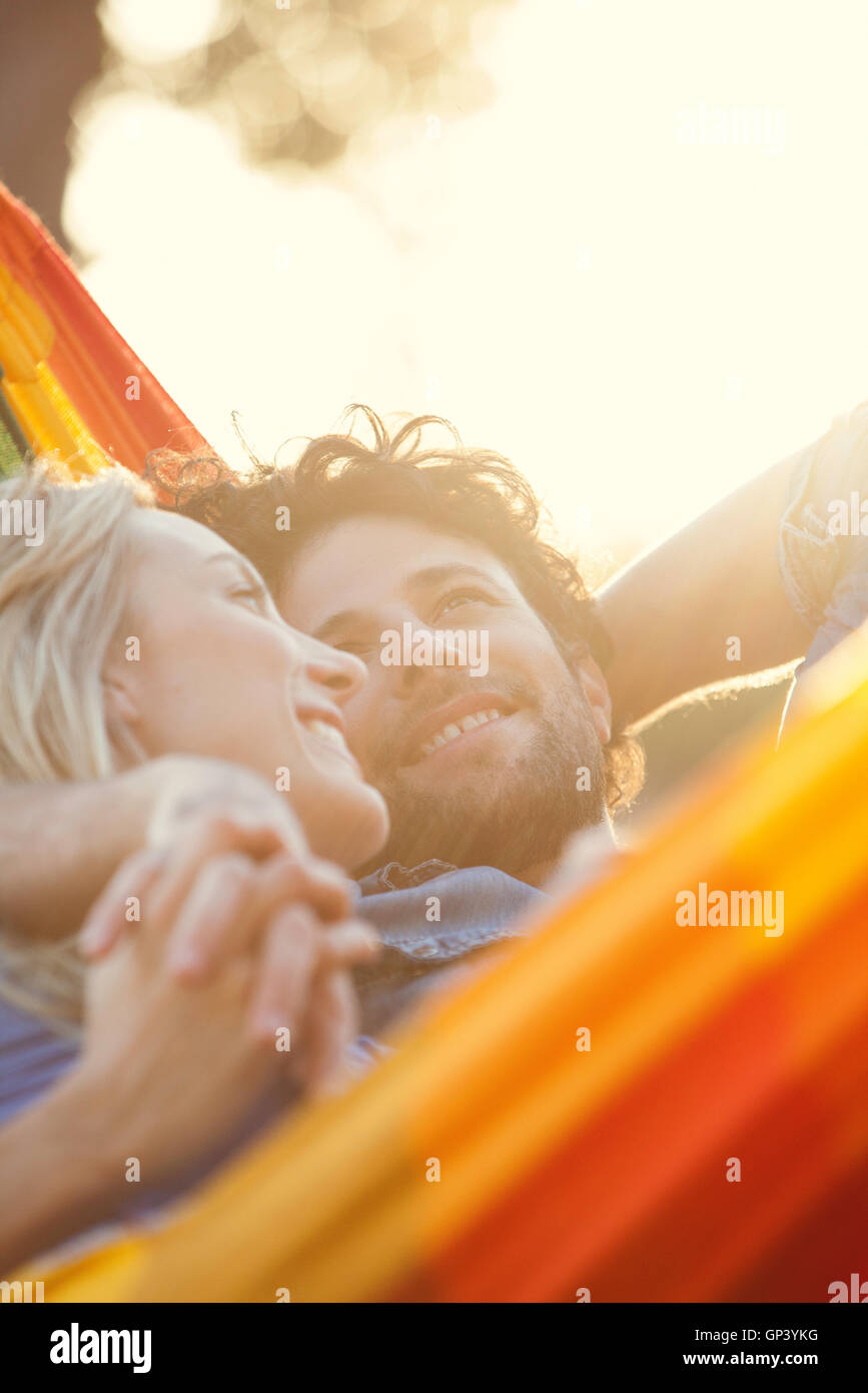 Couple relaxing together in hammock Stock Photo