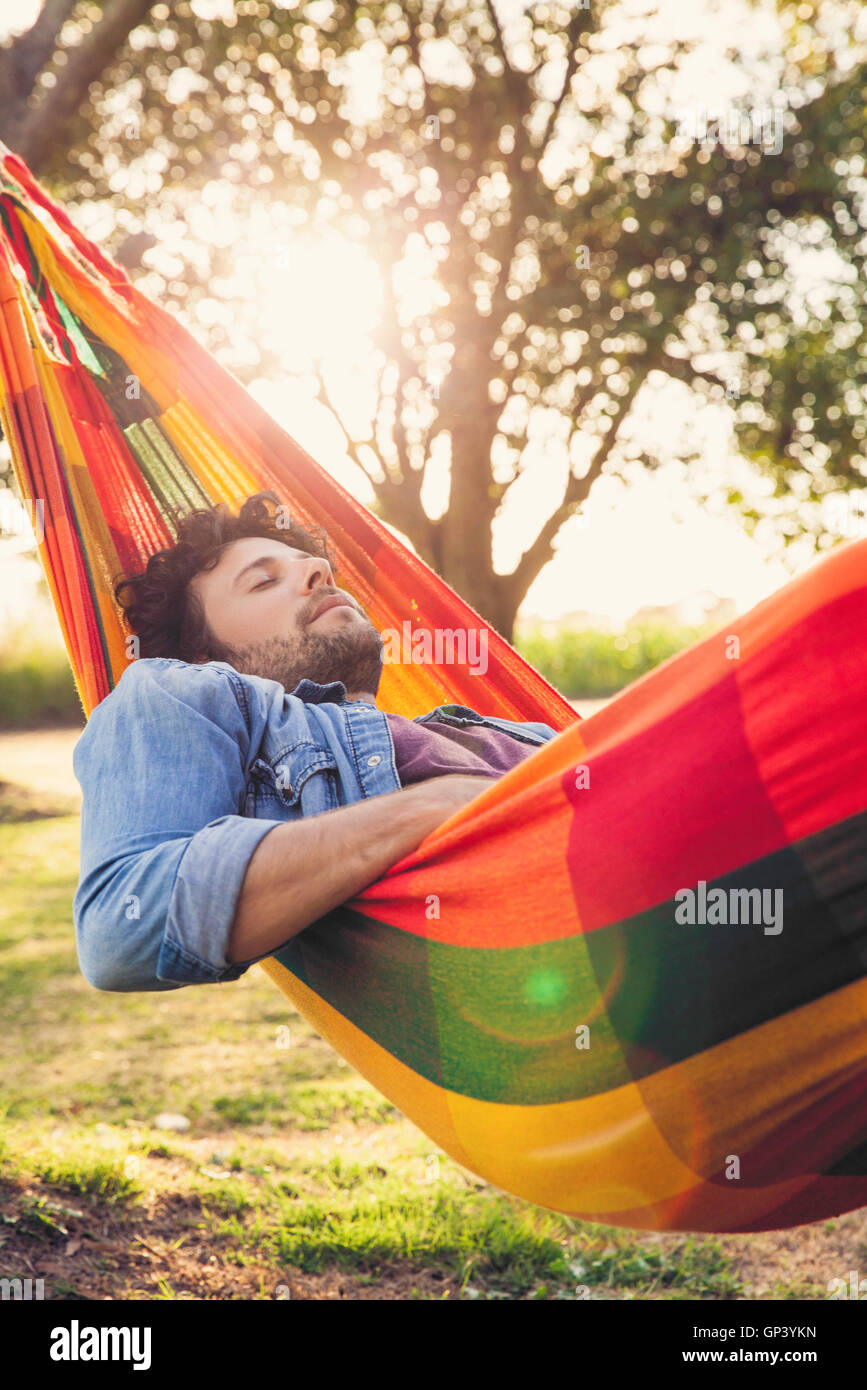 Man napping in hammock Stock Photo