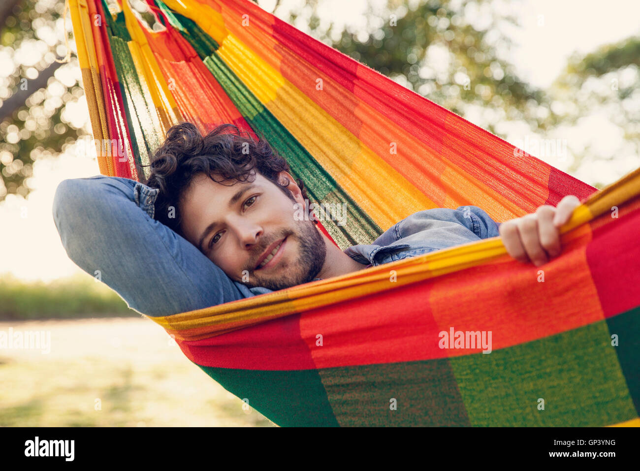 Man relaxing in hammock, portrait Stock Photo