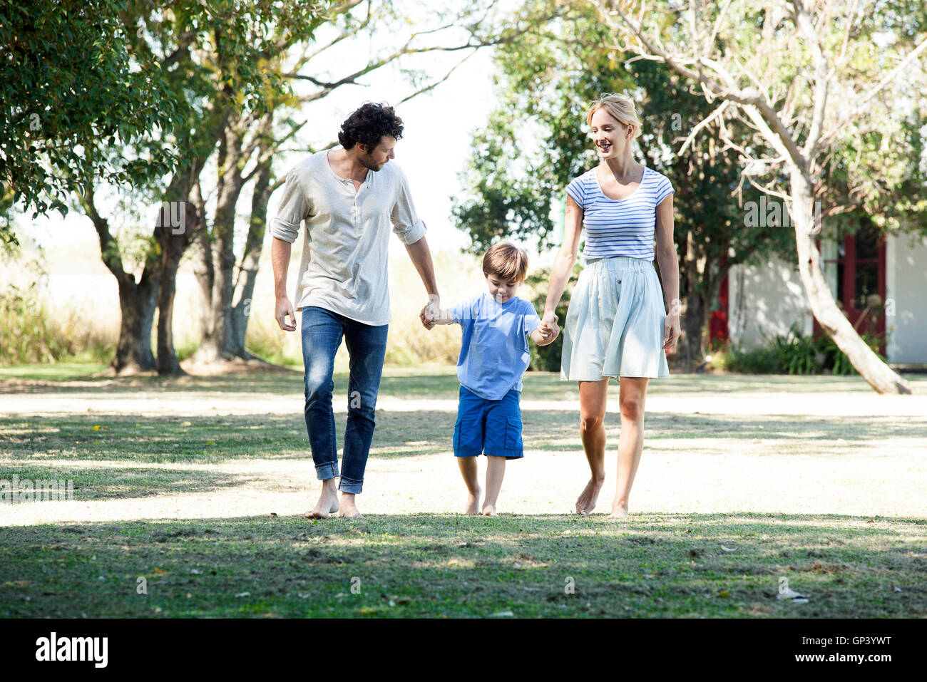 Family with one child taking walk outdoors together Stock Photo