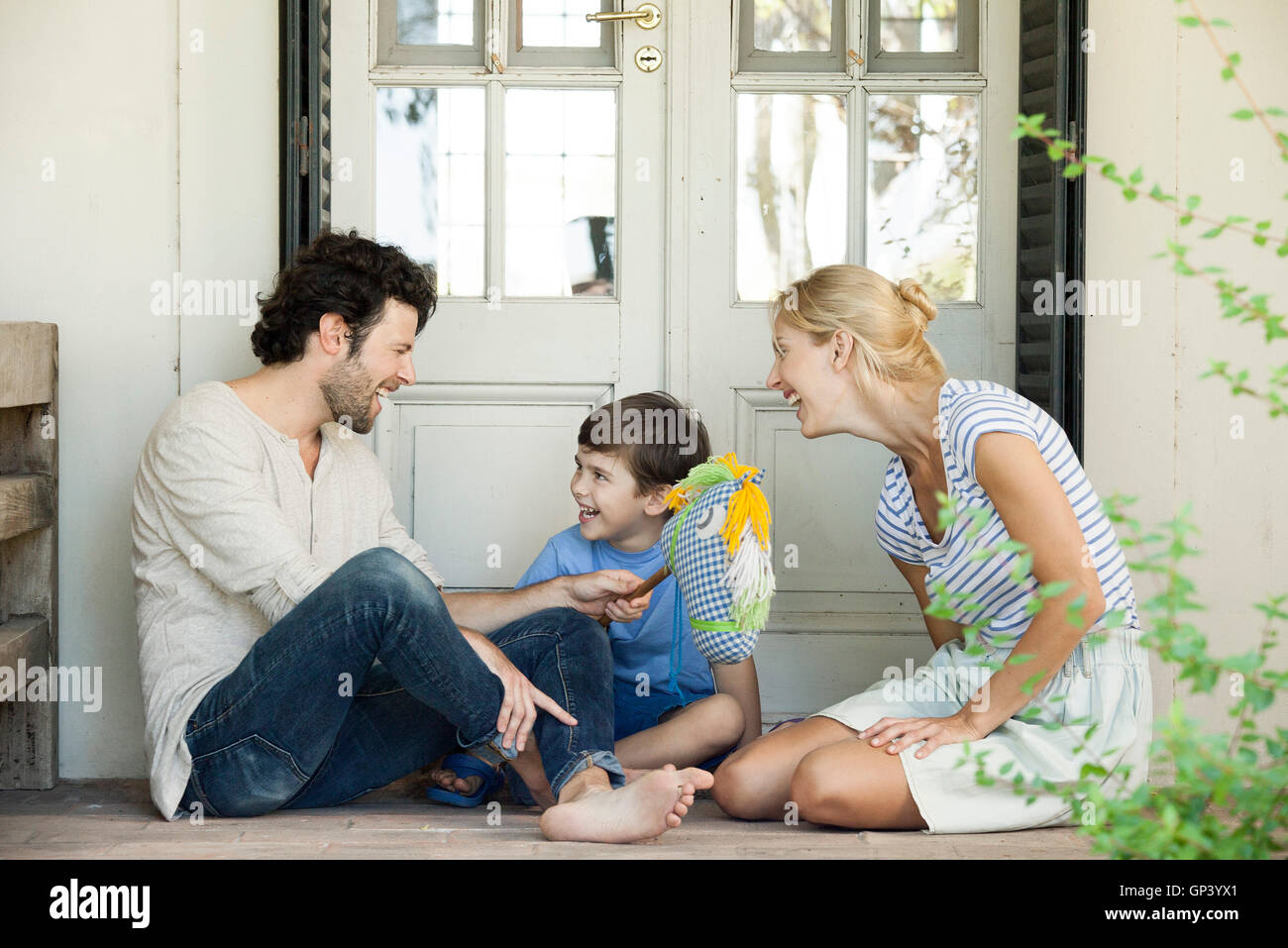Family with one child having lighthearted time together outdoors Stock Photo