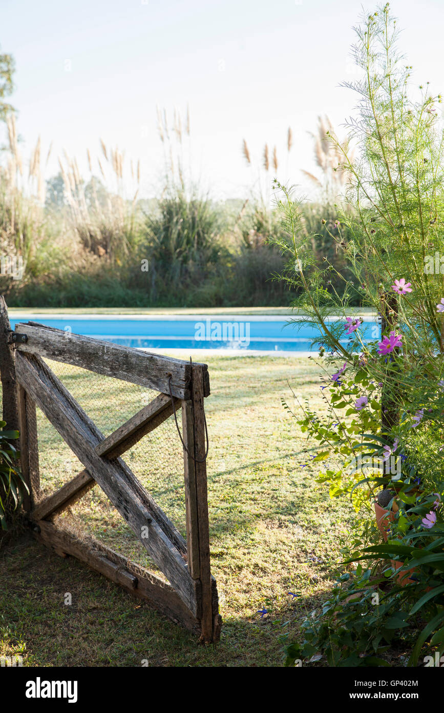 Open gate leading to swimming pool Stock Photo