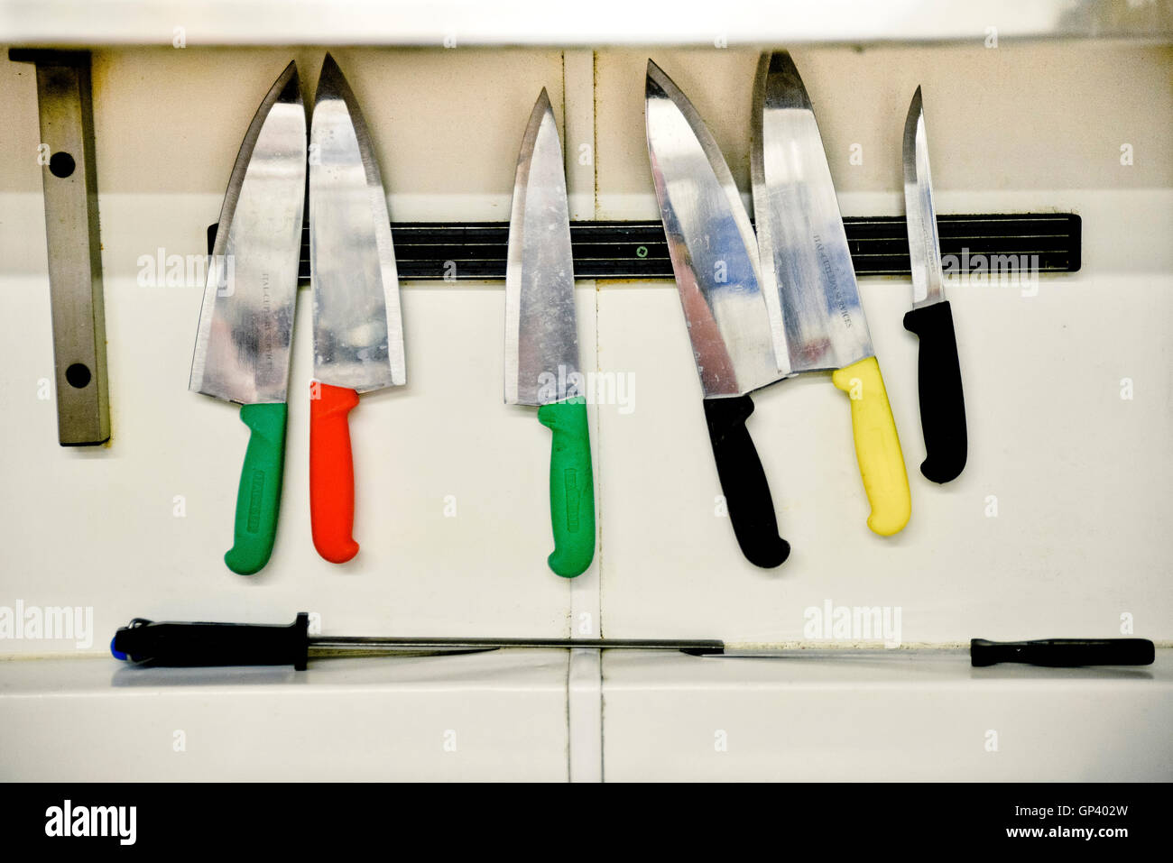 Knives hanging on magnectic strip Stock Photo