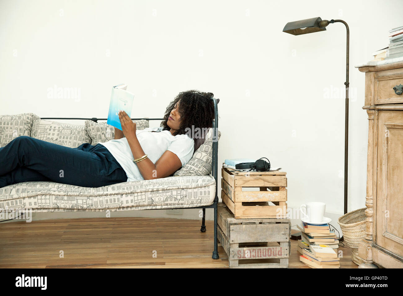 Woman relaxing at home with good book Stock Photo