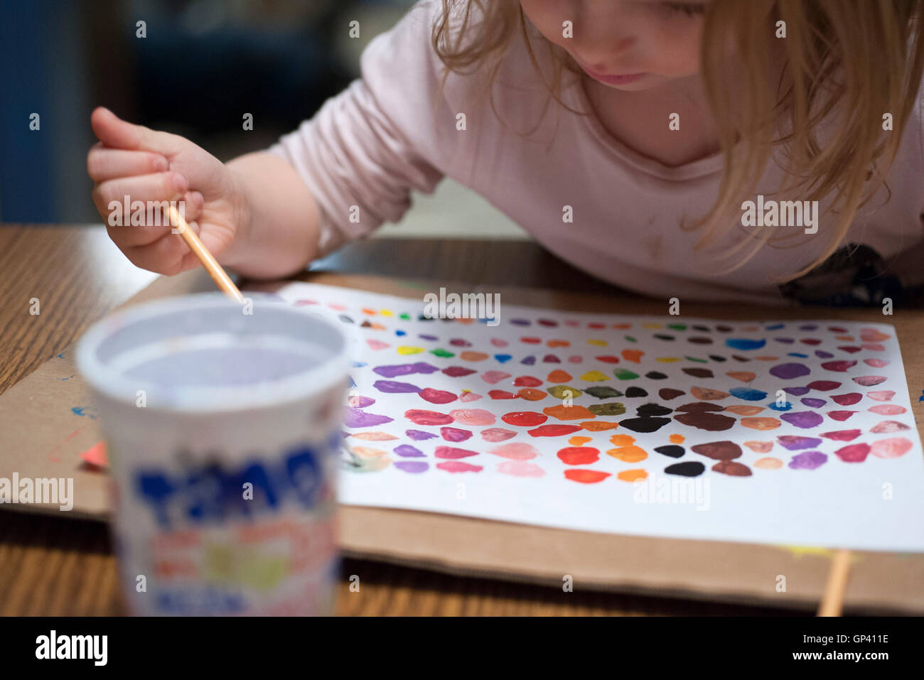 Little girl painting with watercolors Stock Photo - Alamy