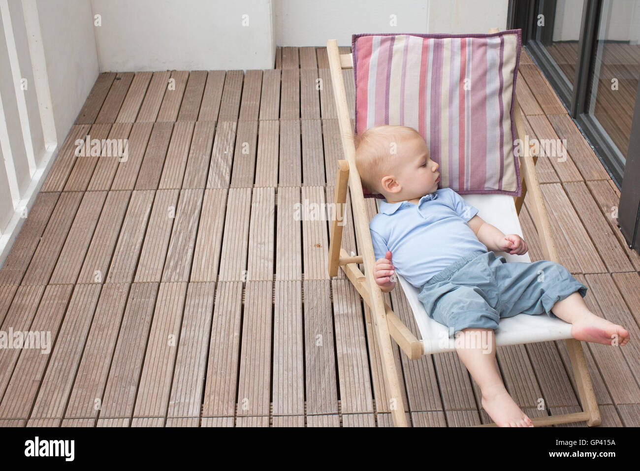 Baby reclining on lounge chair Stock Photo Alamy