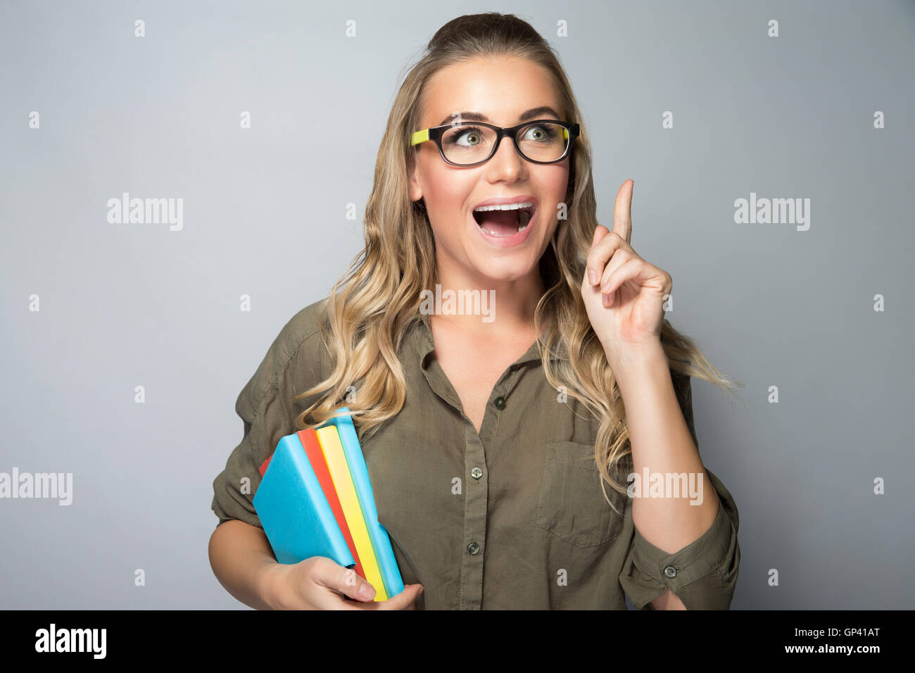 Portrait of a clever student girl, brilliant idea concept, excited