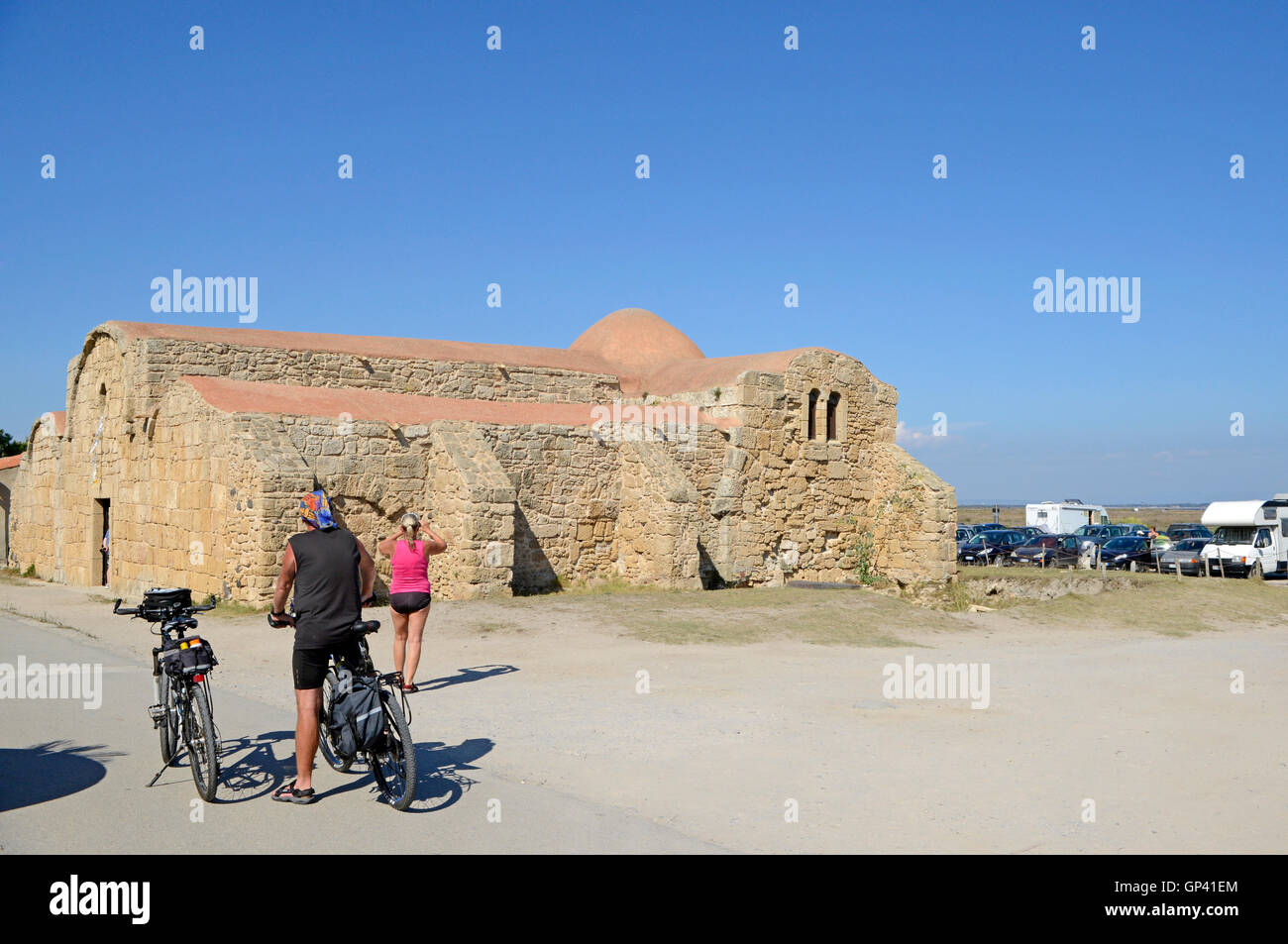 cyclists near Byzantine church of San Giovanni di Sinis, Sinis peninsula, Sardinia, Italy, Europe Stock Photo