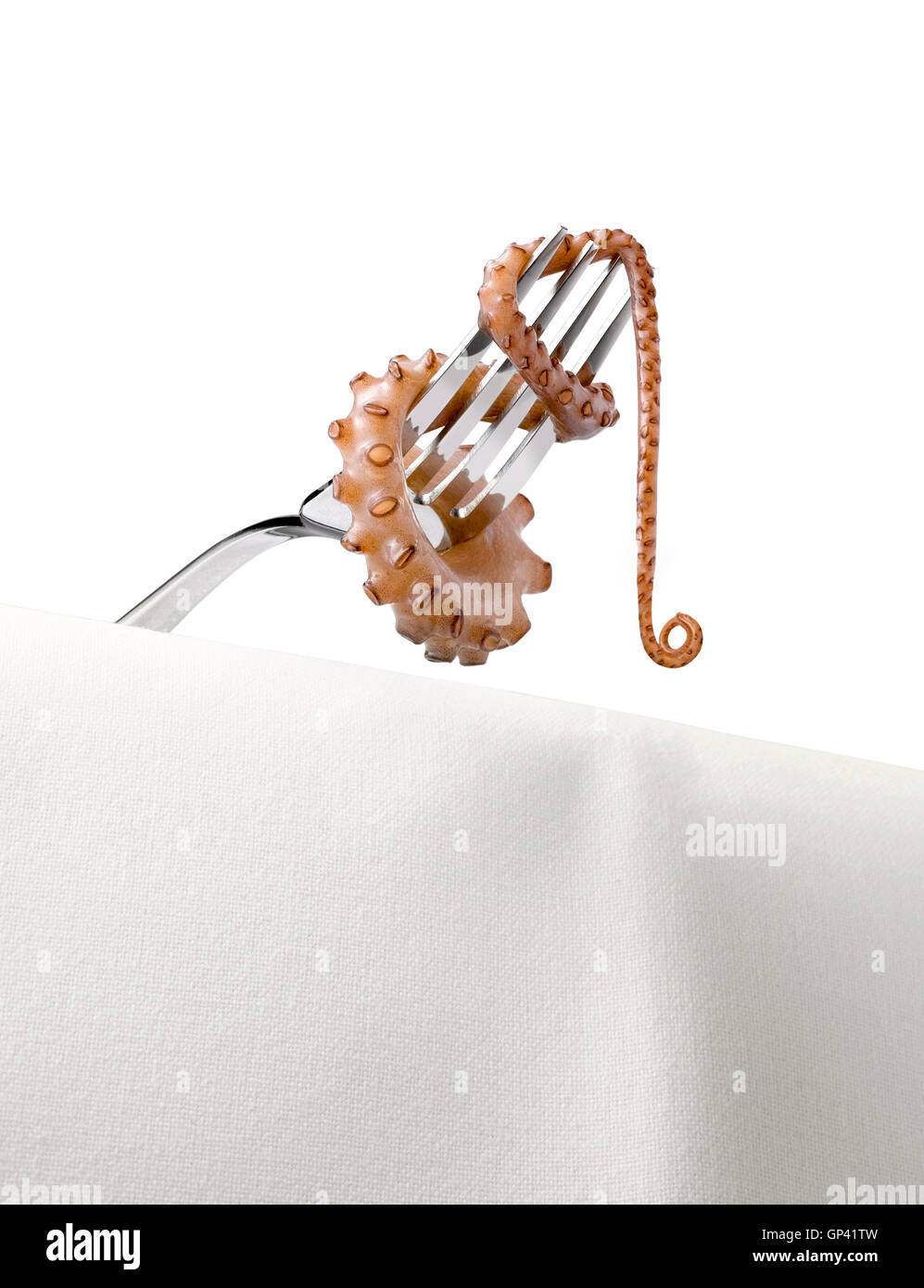 An Octopus tentacle wrapped around and dangling from a silver fork Stock Photo