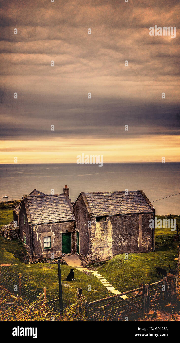 old cottage house on the cliff by the ocean Stock Photo