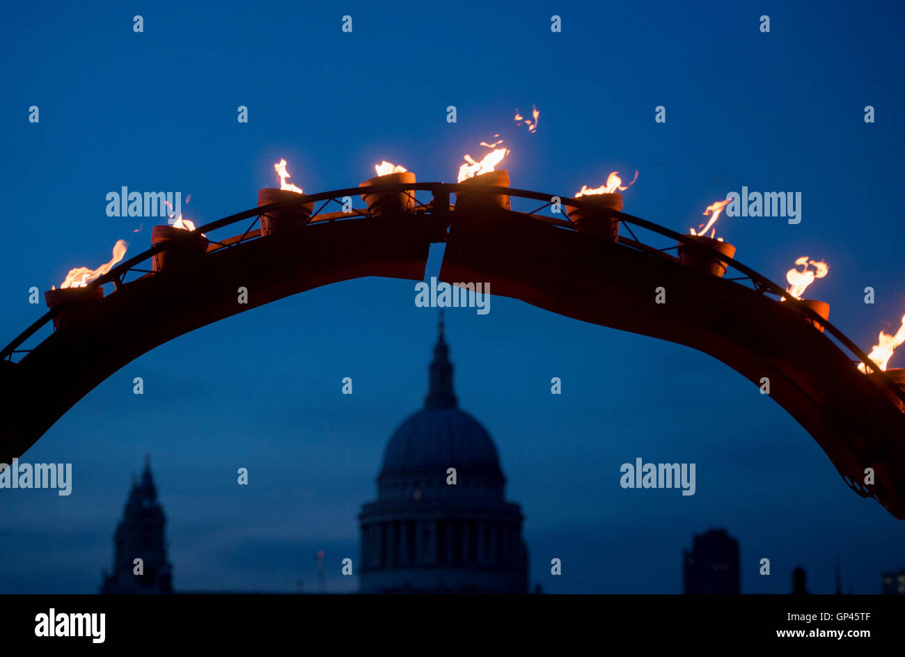 A structure burns in front of St Paul's Cathedral as part of 'Fire Garden' by Compagnie Carabosse, in front of the Tate Modern in London to mark the 350th anniversary of the Great Fire of London. Stock Photo