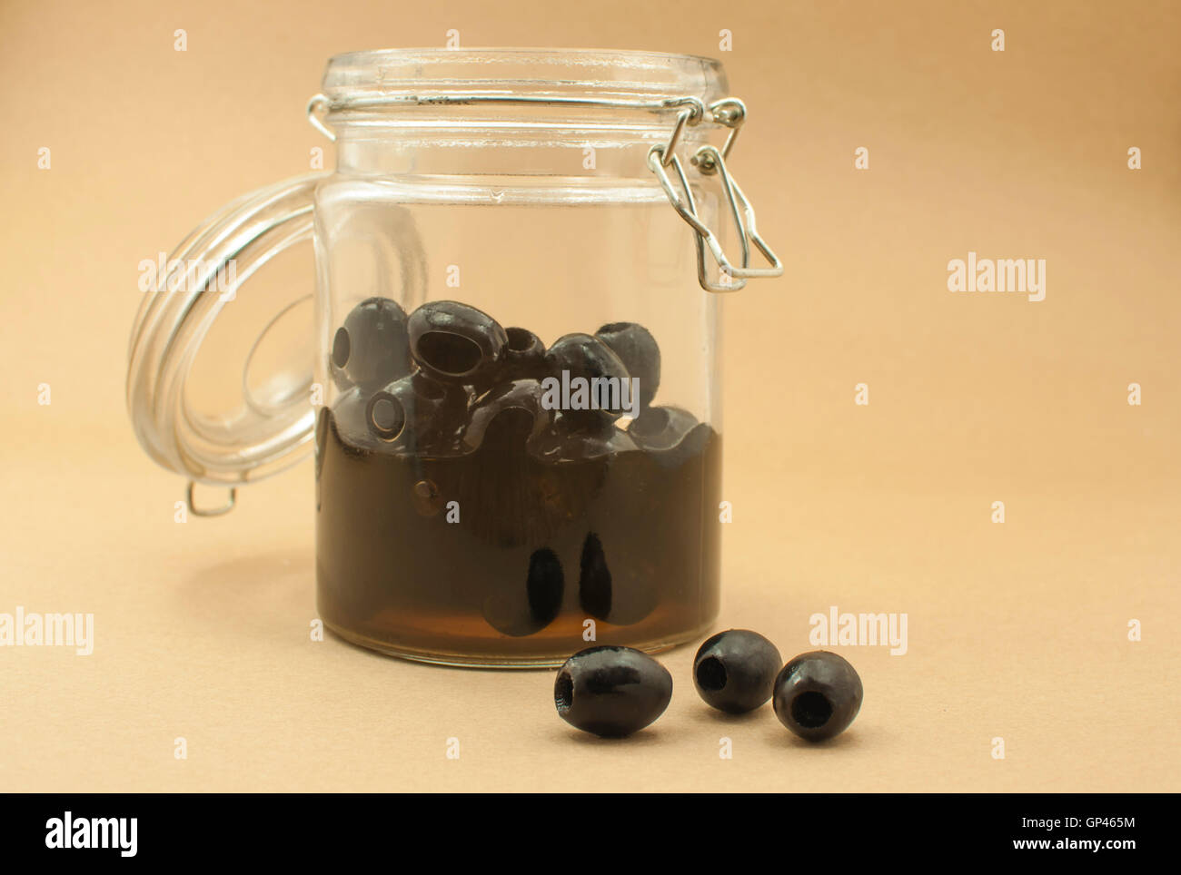 pickled black olives in glass bottle Stock Photo