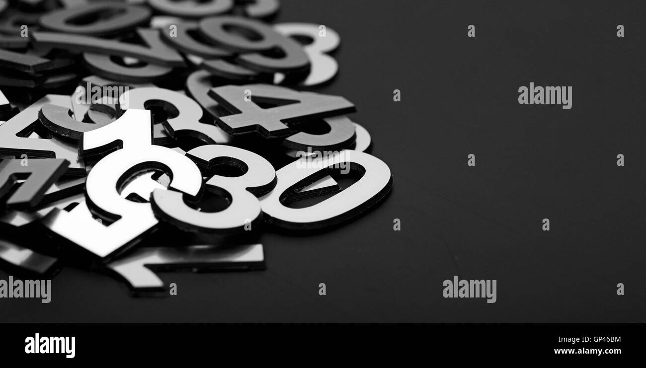 closeup image with pile metal numbers on black background Stock Photo