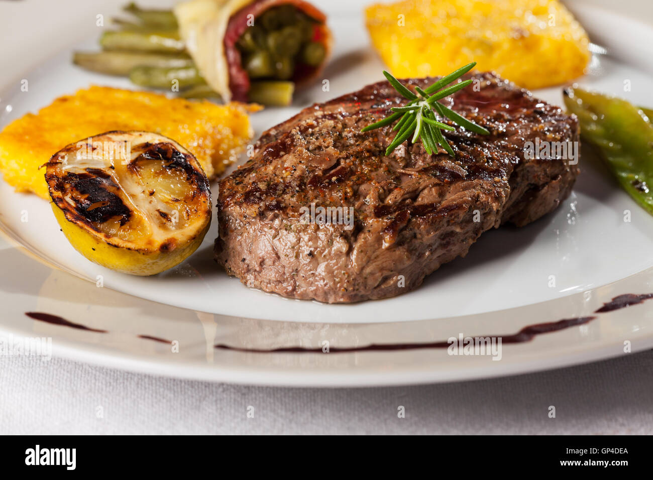 steak with a rosemary leaf Stock Photo Alamy