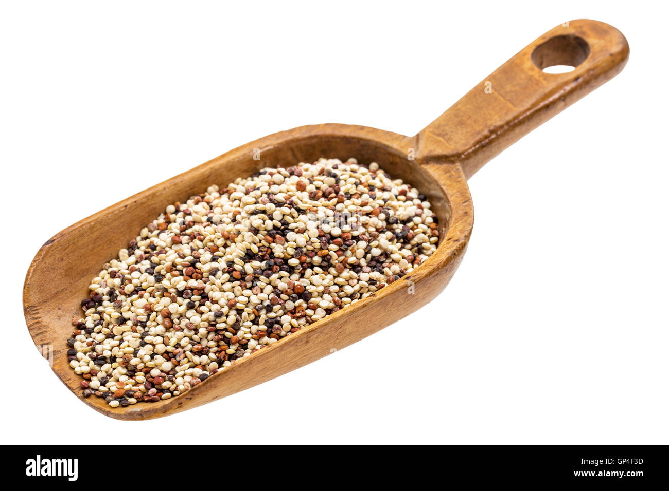 gluten free rainbow quinoa grain on a rustic wooden scoop, isolated on