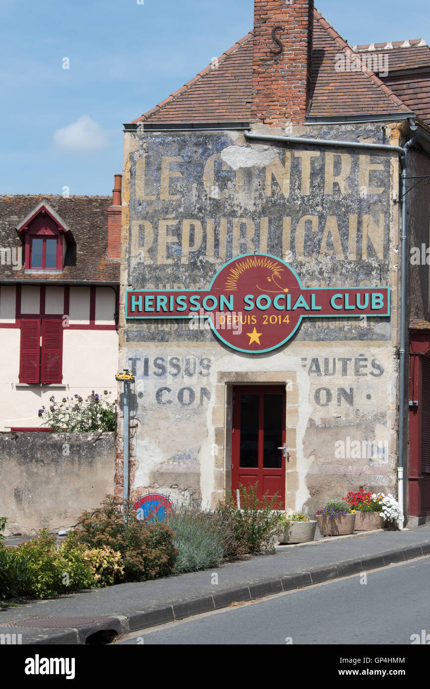 Old advertising on a building in the ancient town of Herisson in the Allier department Auvergne France Stock Photo