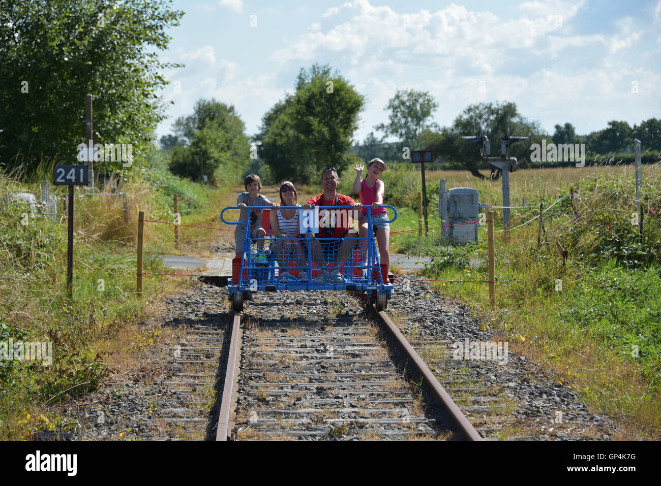 A family enjoying a day out on a velorail Stock Photo