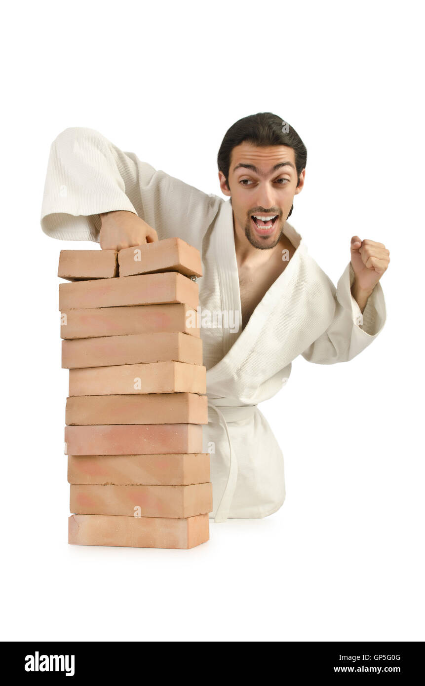 Karate man breaking bricks on white Stock Photo
