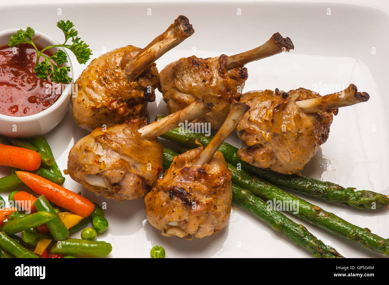chicken legs with asparagus and ketchup Stock Photo