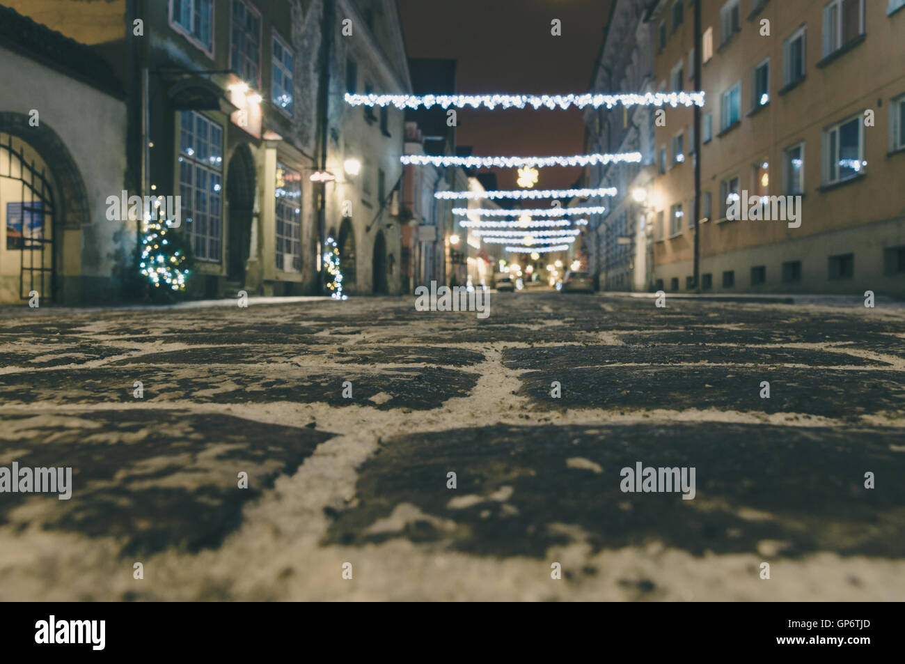 Blurred image of street decorated with Christmas illumination. From ground view Stock Photo