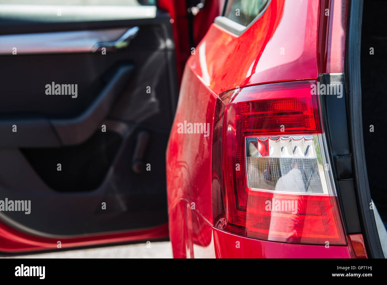 Close Up Of A Back Car Light Red Car With Open Side Door And