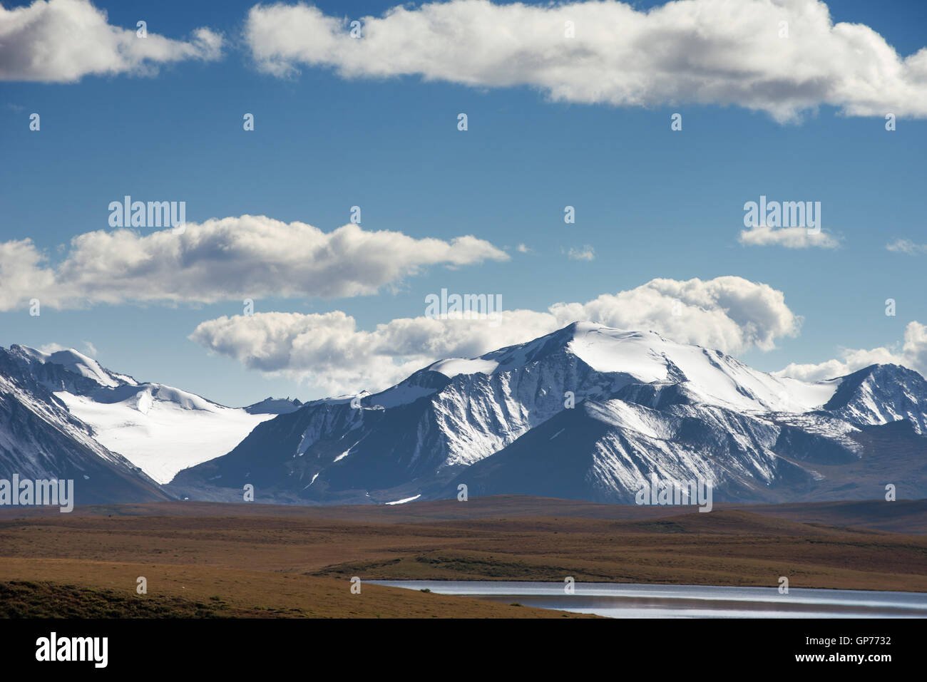 Big snowy mountain peaks on blue sky backdrop Stock Photo