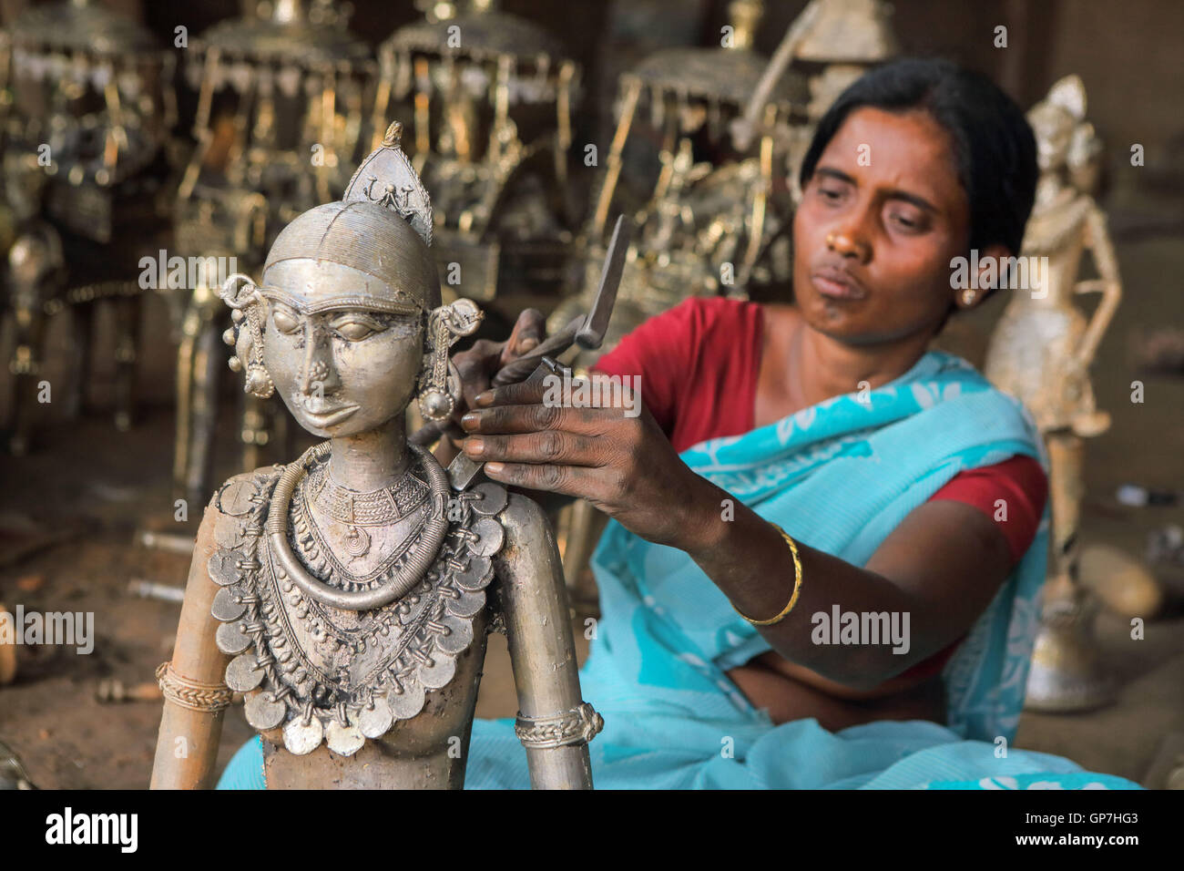 Woman crafting handicrafts out of wrought iron, bastar, chhattisgarh, india, asia Stock Photo