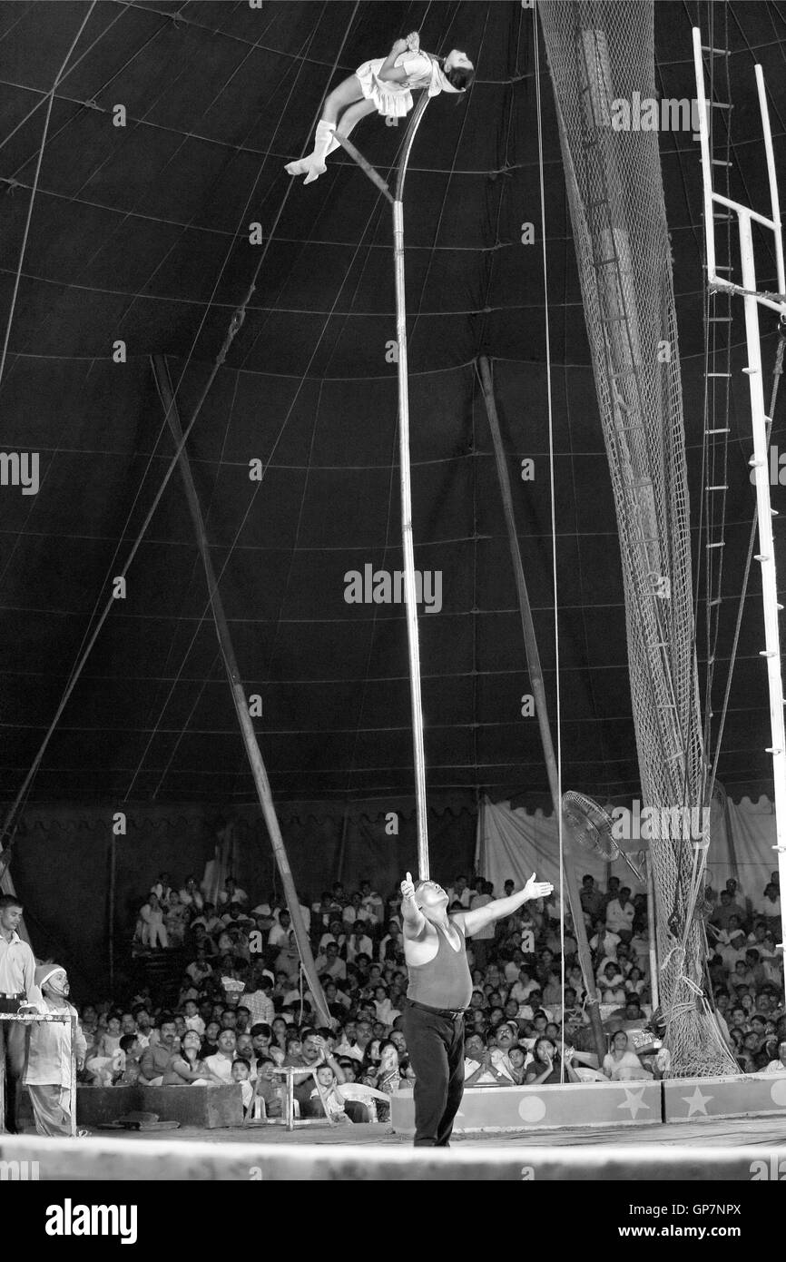 Man balancing girl on stick in circus, india, asia Stock Photo