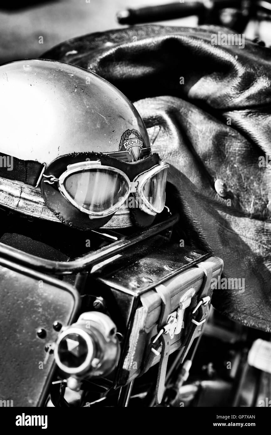 Old vintage motorcycle helmet and goggles on a vintage motorcycle. UK. Black and white Stock Photo
