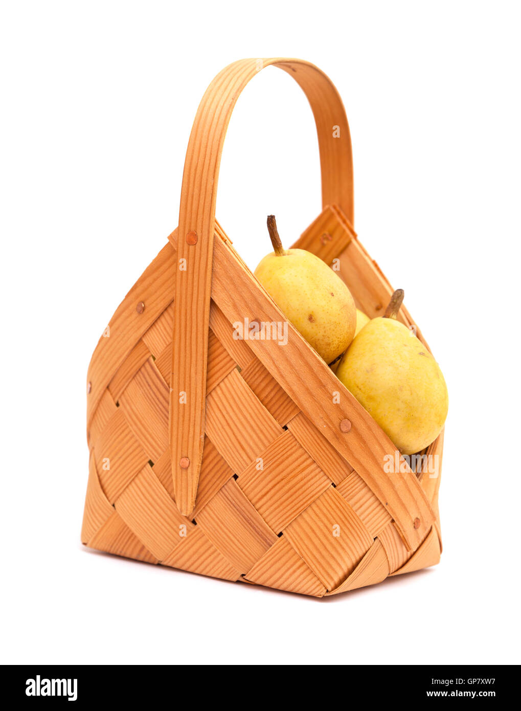 small birch bark basket full of small yellow pears isolated on white background Stock Photo