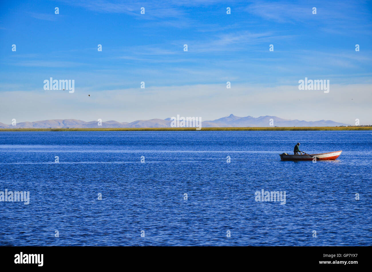 PUNO REGION, PERU: MAY 31, 2013: Fisherman in his boat on Titicaca Lake Stock Photo