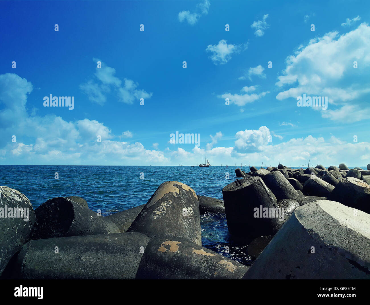 Huge stones in the sea at Balchik city, Bulgaria. Summer vacation background with a ship floating on far. Stock Photo