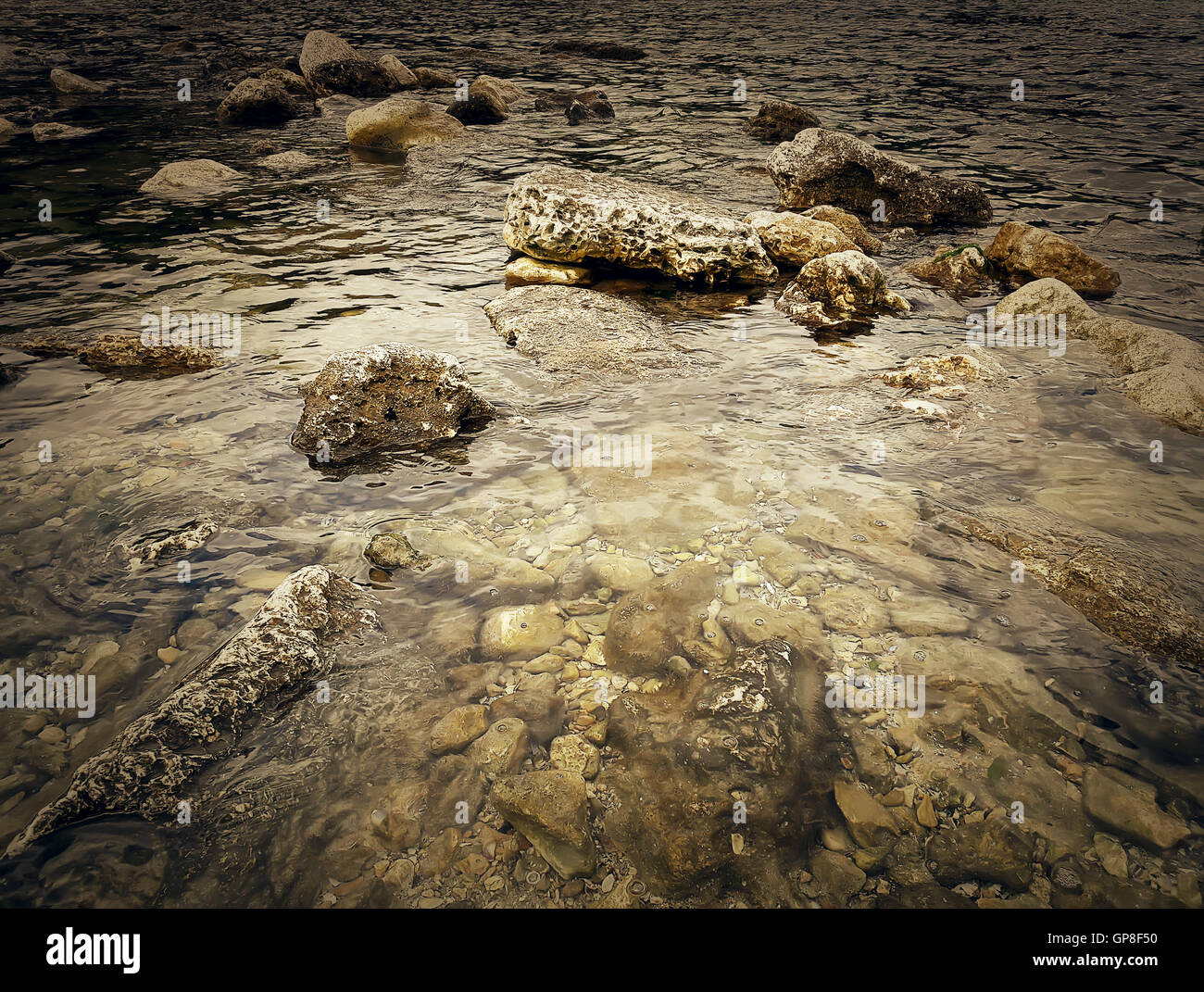 Underwater texture of a rocky seafloor with stone pieces Stock Photo