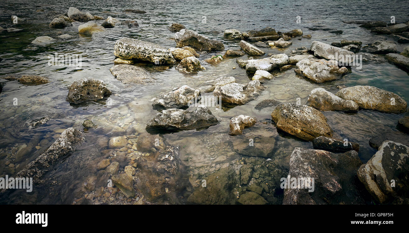 Underwater texture of a rocky seafloor with stone pieces Stock Photo