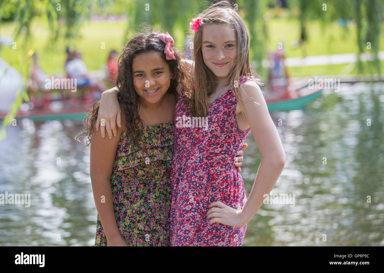 Portrait of two Hispanic teen sisters posing together in a park Stock Photo