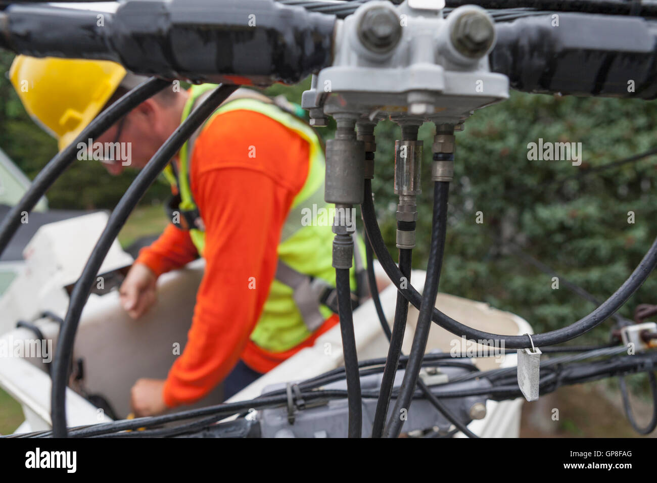 Cable lineman reaching for tools in a bucket lift Stock Photo Alamy