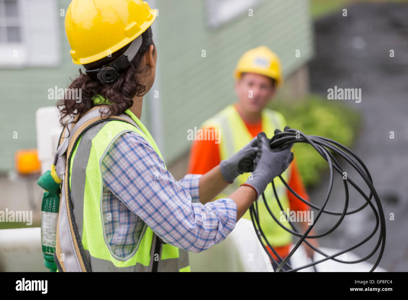 Hispanic female cable lineman looping the cable in bucket lift Stock ...
