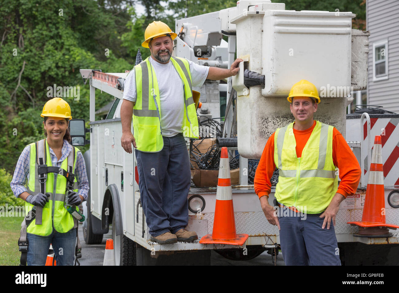 Portrait of happy utility workers at their bucket truck Stock Photo Alamy