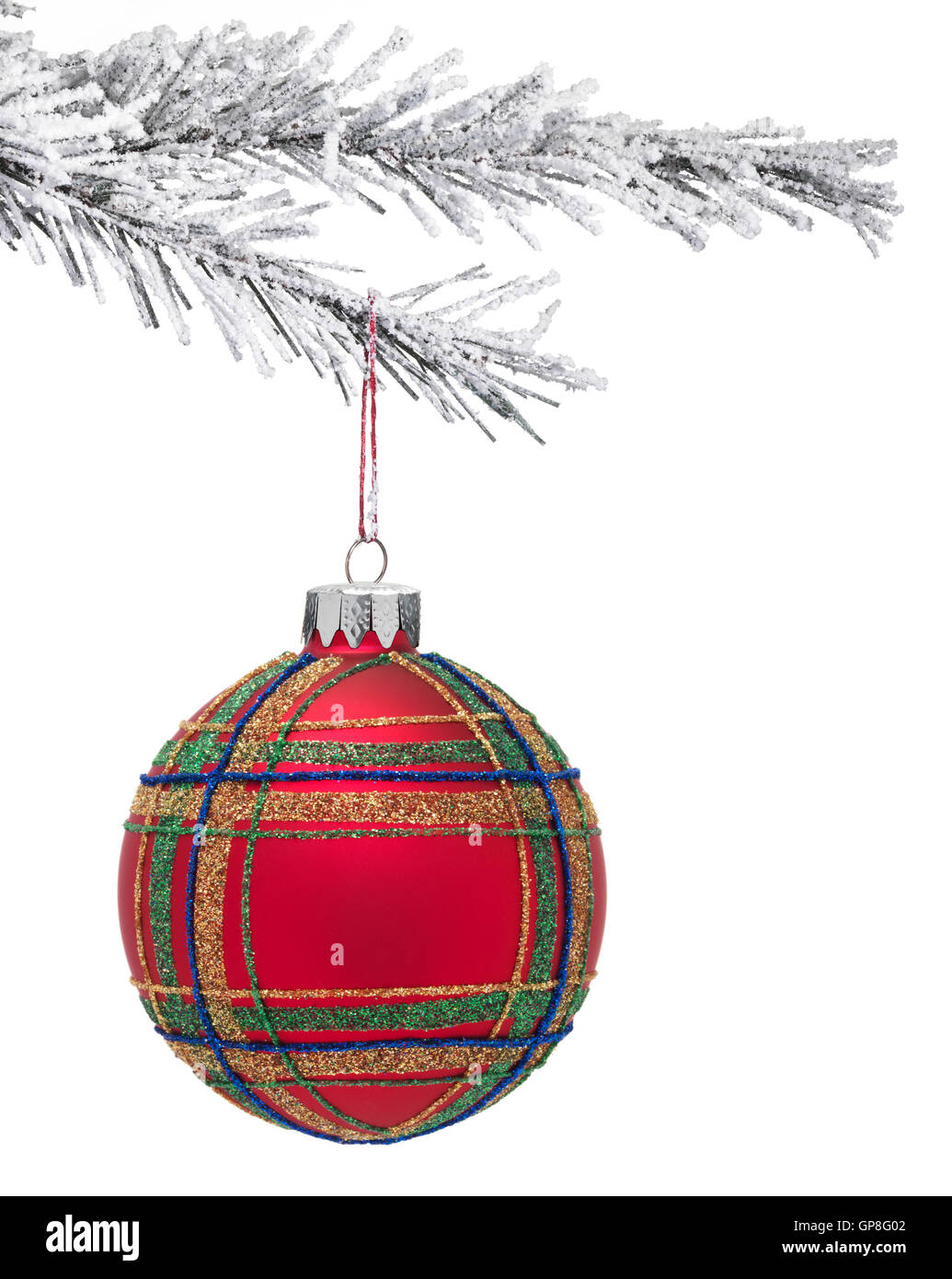 Snow covered Christmas tree with a red Bauble hanging on a white background Stock Photo
