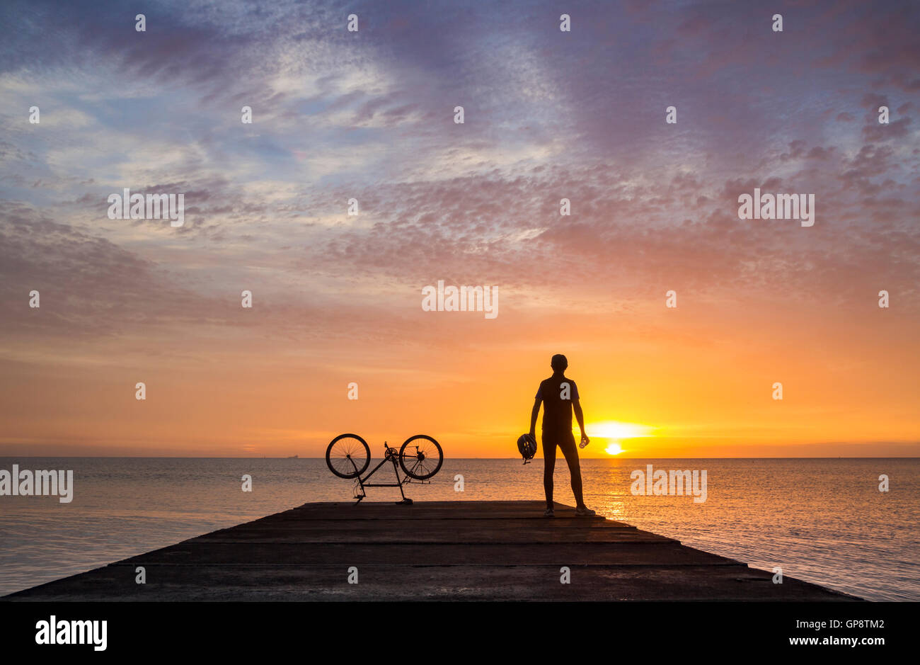Mountain biker silhouetted at sunrise. UK Stock Photo