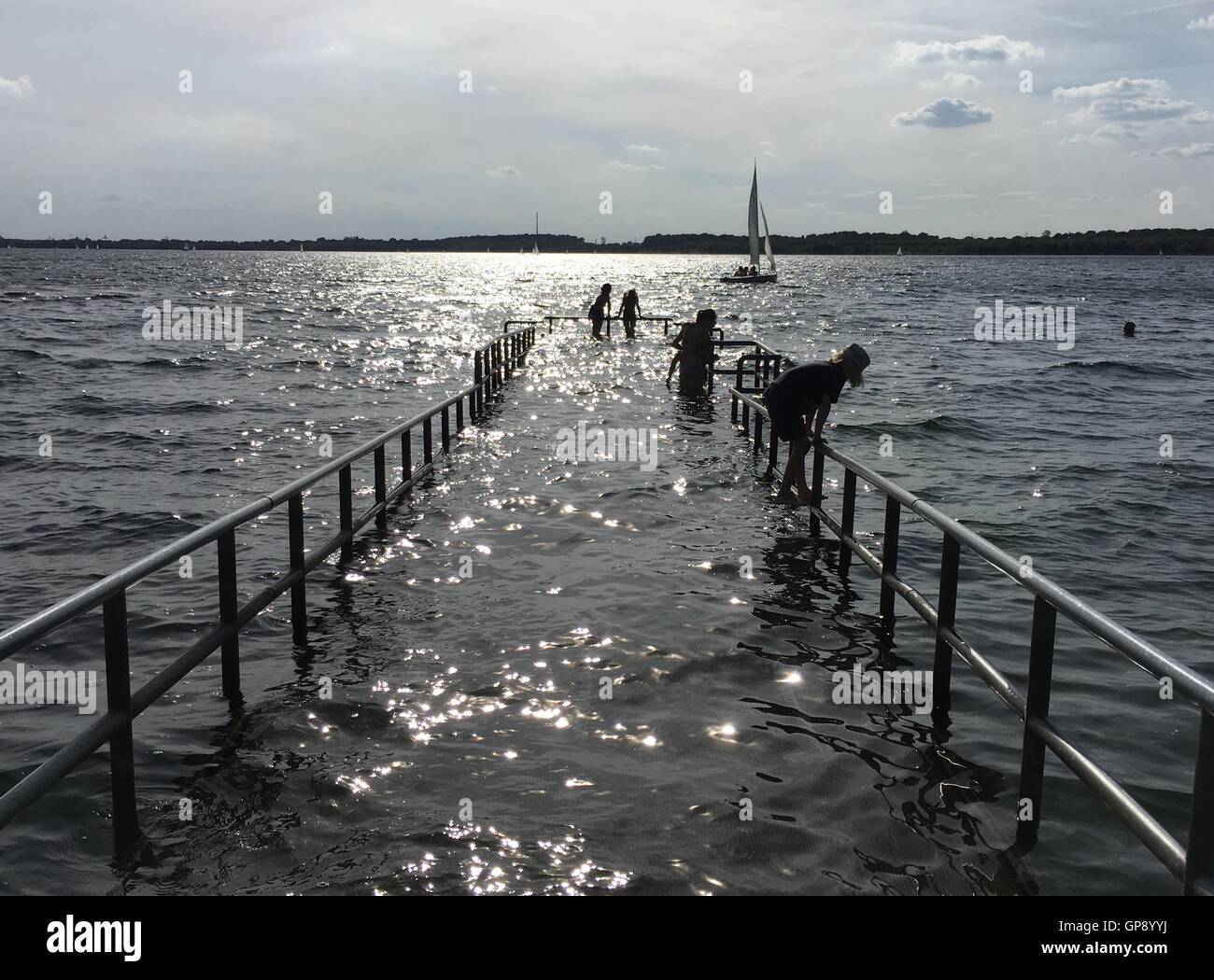 Leipzig, Germany. 03rd Sep, 2016. People swim at a dock for wheelchair users at Cospudener See lake in Leipzig, Germany, 03 September 2016. Photo: JAN WOITAS/dpa/Alamy Live News Stock Photo