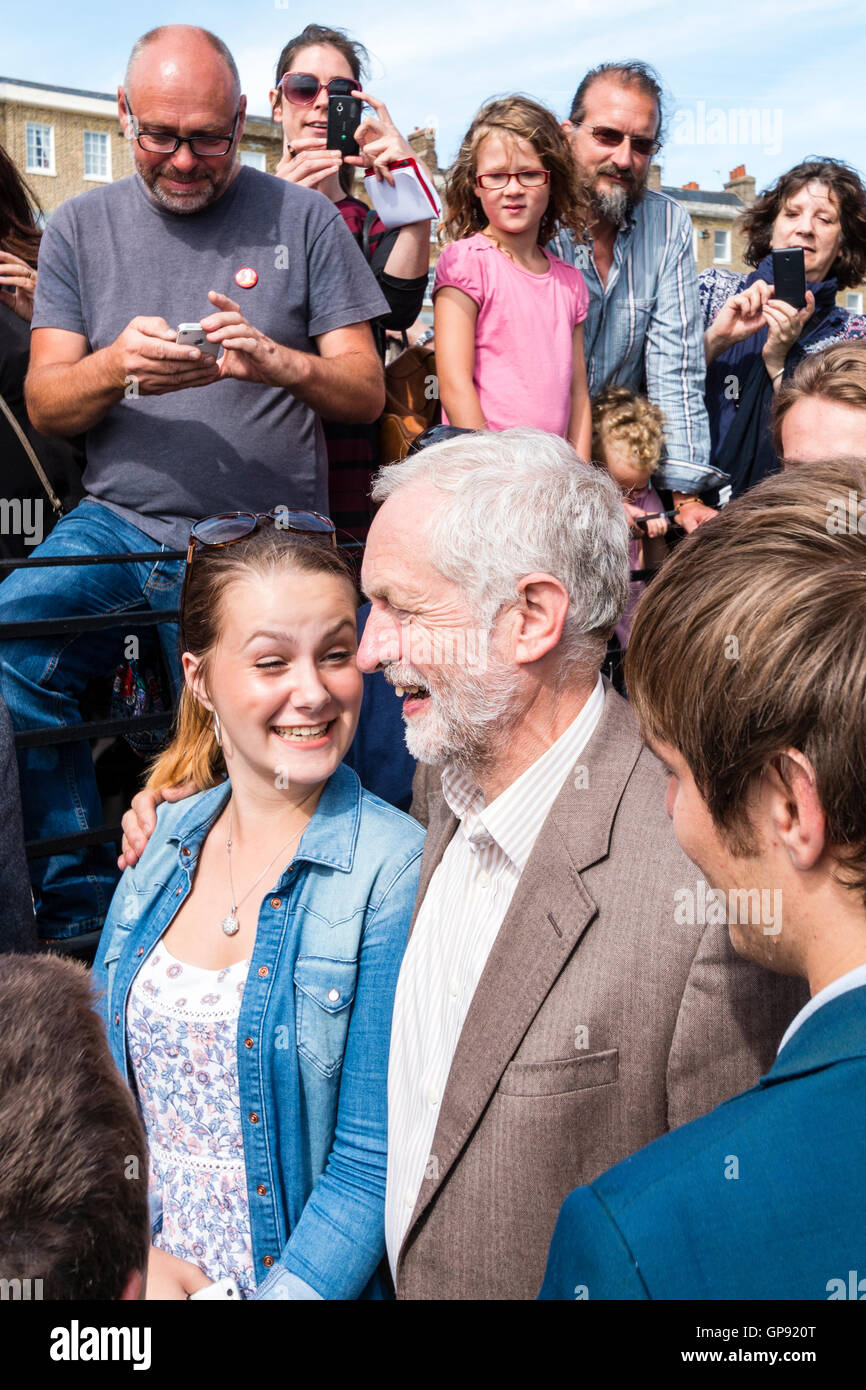 Jeremy Corbyn, Labour Party Leader, posting for photograph with a young woman supporter after a speech at a Thanet Momentum rally in Ramsgate. Stock Photo