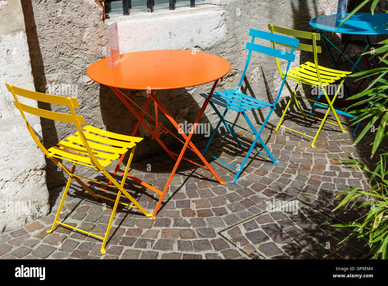 Colourful table and chairs in a French pavement café. Stock Photo