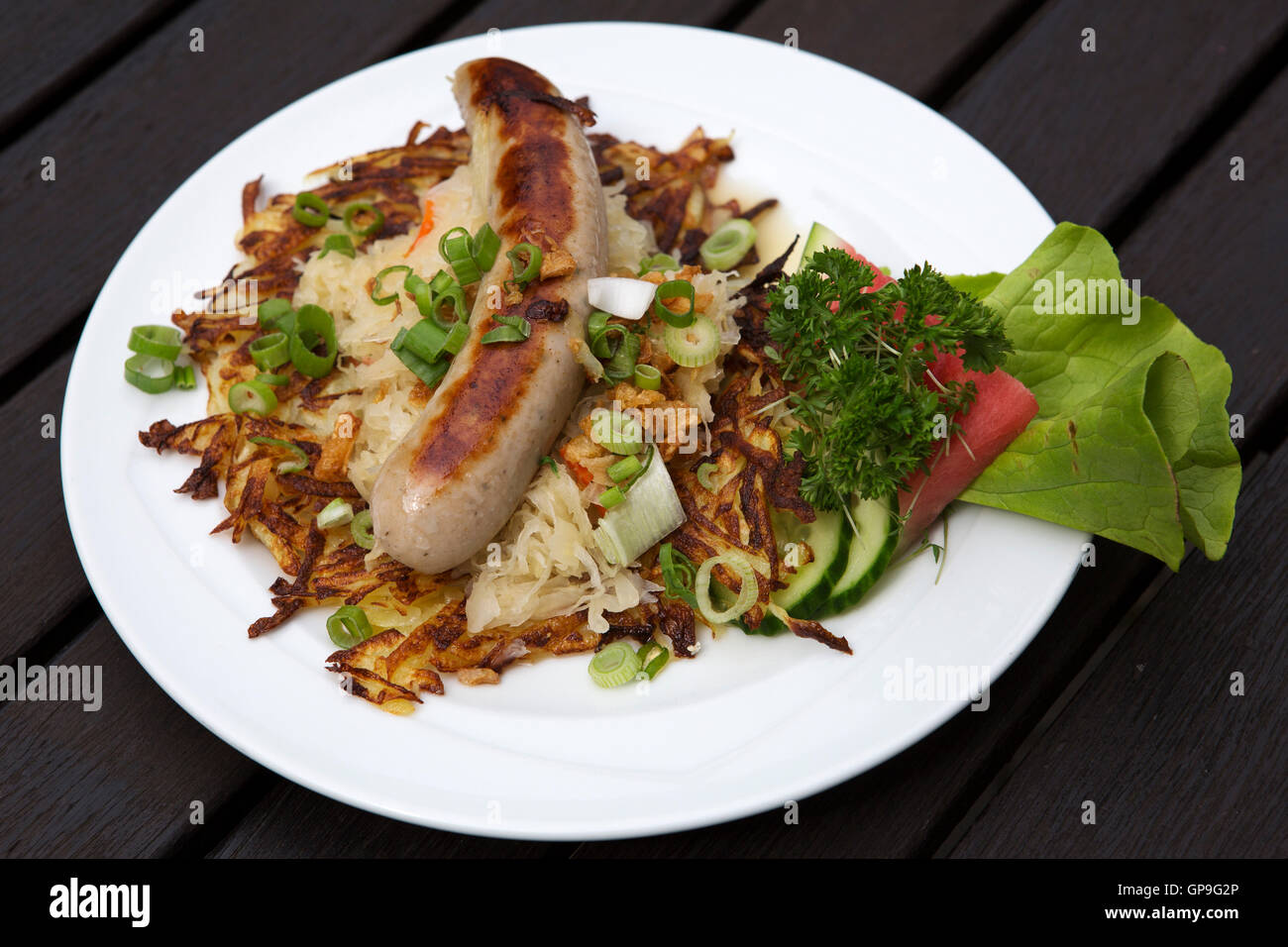 Thuringian bratwurst (grilled sausage) served with sauerkraut and salad