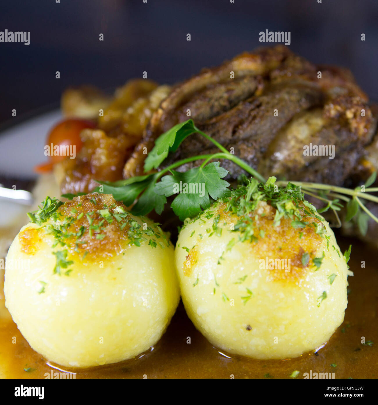 A Schweinshaxe (pork knuckle) served with potato dumplings in Dresden