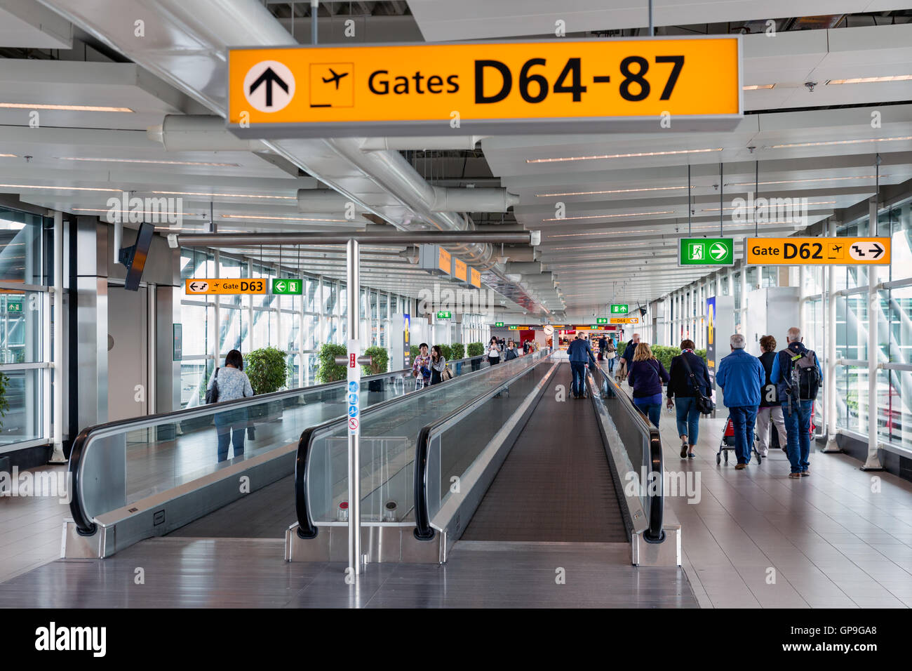 SCHIPHOL, THE NETHERLANDS - MAY 16, Travellers walking to the gate on May 16, 2016 at Schiphol Airport, The Netherlands Stock Photo