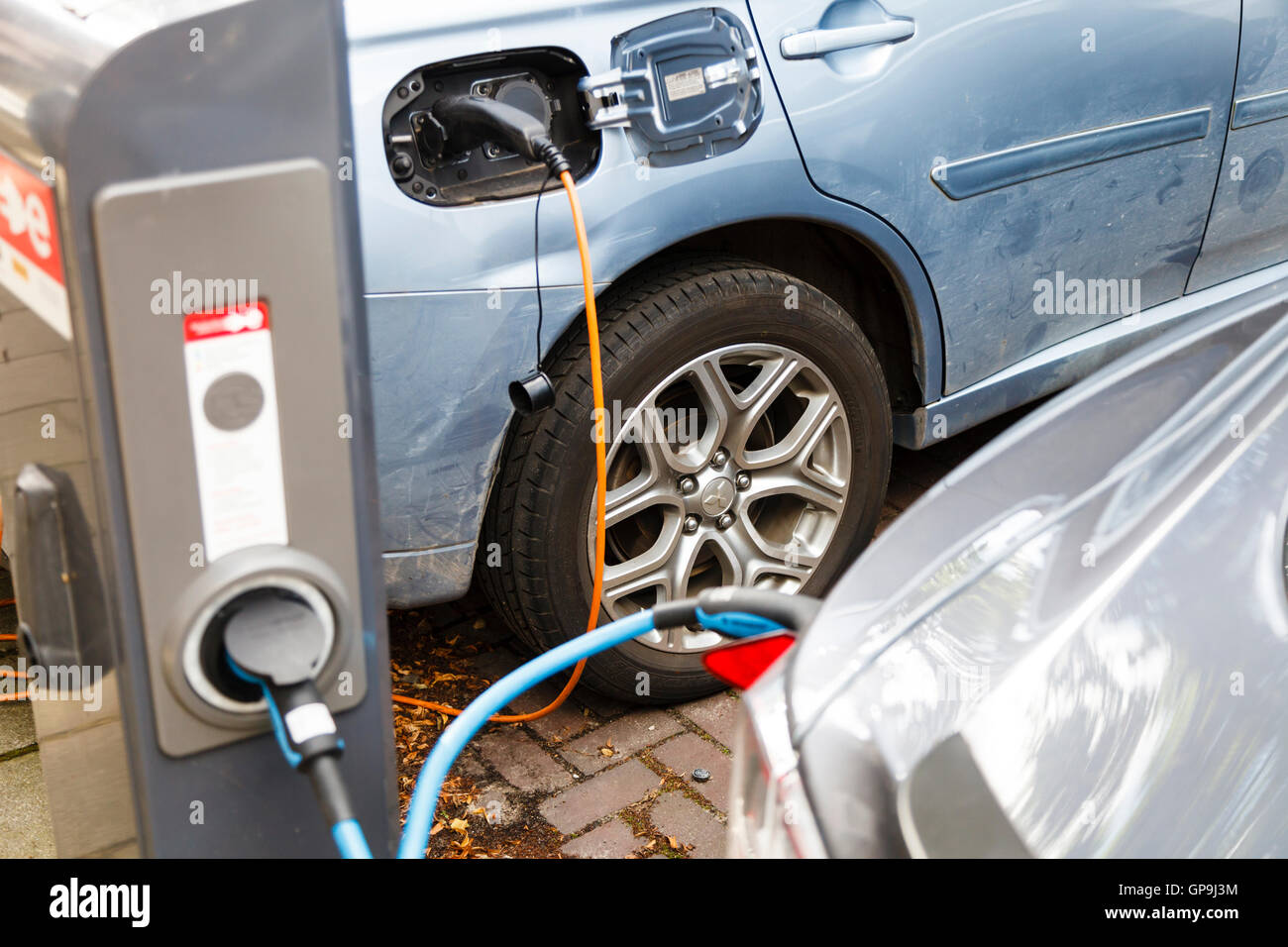 Electric cars parked and connected to a charging point in Amsterdam