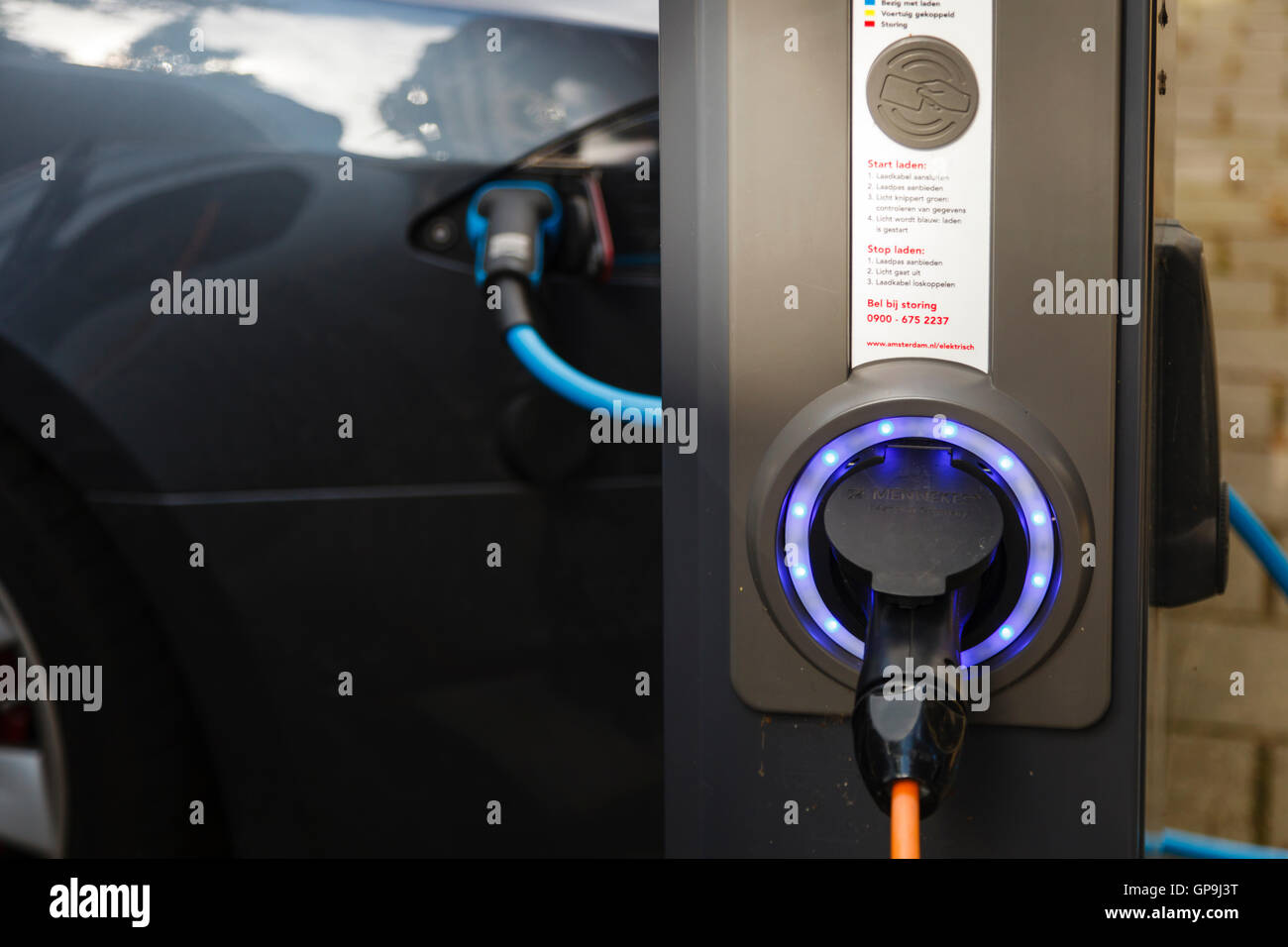 Electric cars parked and connected to a charging point in Amsterdam